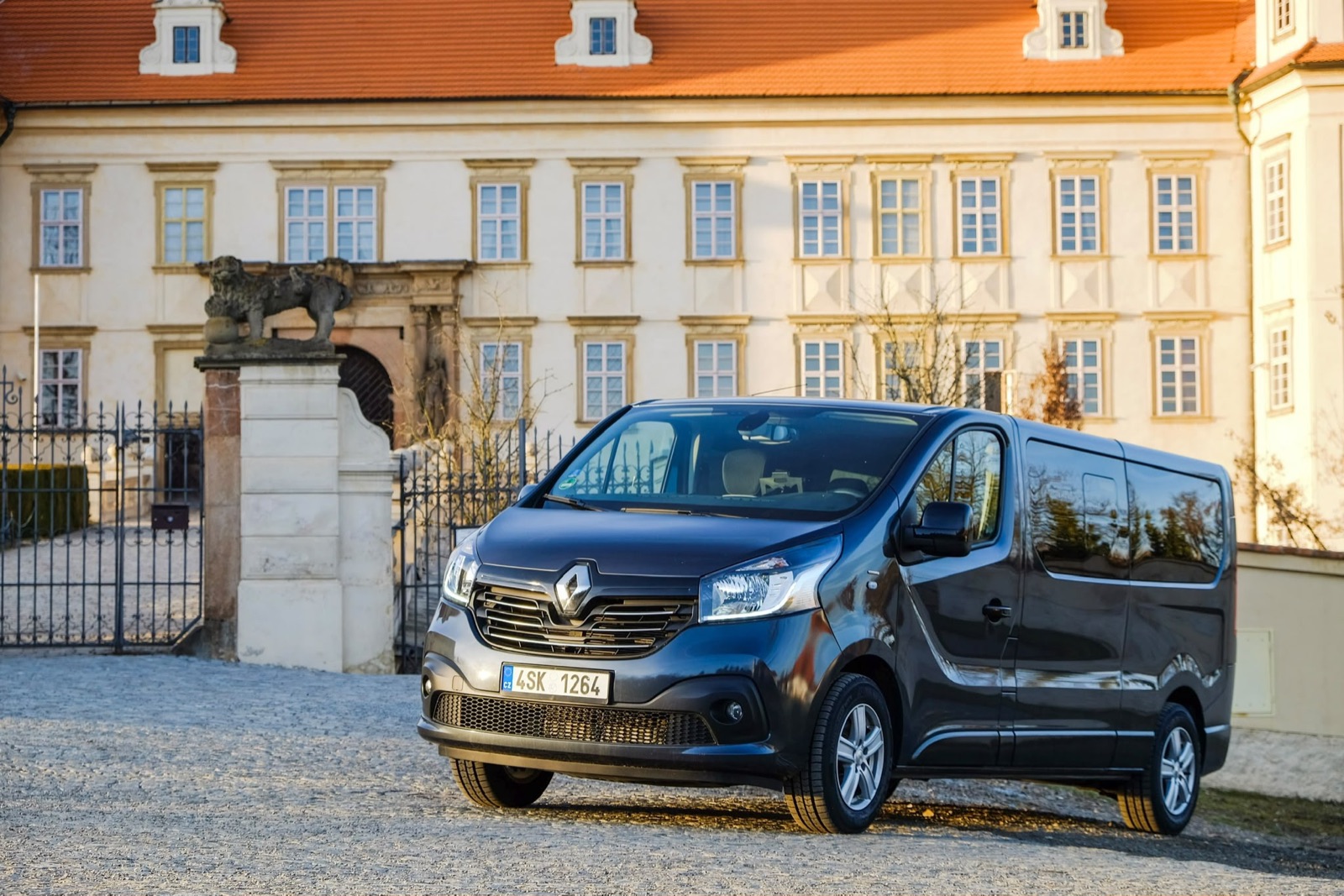 Passenger van outside a historic building on a previous journey